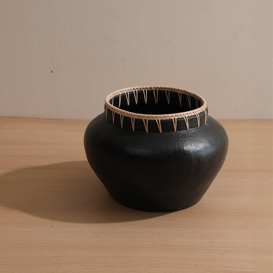 black decorative pot, handmade black ceramic pot, tribal style black vase,
black clay vase with wicker trim, black pot with natural fiber rim,
handcrafted black ethnic vase for home, black tribal pot with cane detailing .