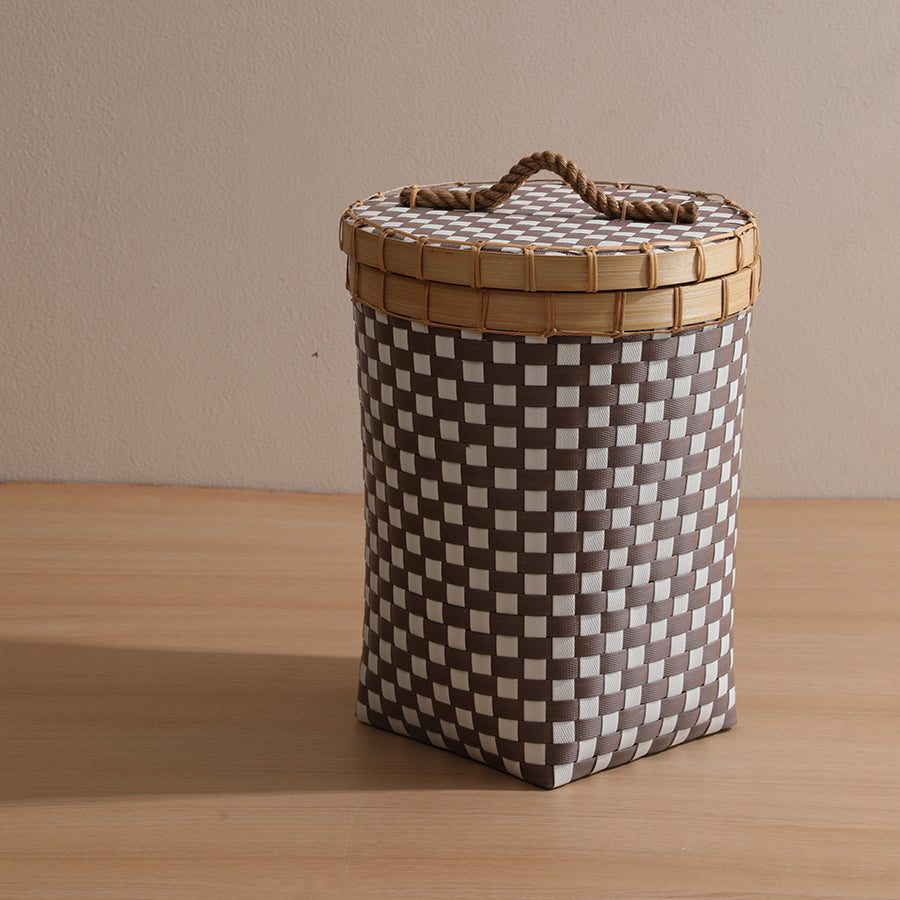 Small woven storage basket, Checkered hamper with lid, Plastic wicker basket with handle, Compact laundry basket with lid, Decorative storage hamper, Small checkered storage basket with rope handle, Brown and white woven bin with lid, Space-saving hamper for kids’ room.