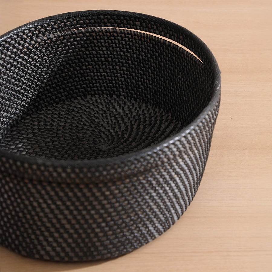 Black woven basket, Round storage basket, Handwoven rattan basket, Black wicker bin, Decorative black storage basket, Minimalist handwoven round basket, 
Black wicker basket for shelf or table, 
Handmade rattan storage bin for home décor, Functional home organization basket, Boho minimalist décor basket, Eco-friendly handcrafted storage solution, 
Stylish entryway catchall basket, 
Modern tabletop storage accessory .