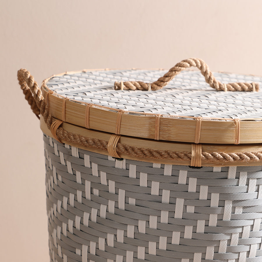 Woven laundry basket with lid, Handmade storage basket, Bamboo and rope laundry hamper, Lidded woven basket, Eco-friendly laundry bin, Grey woven basket with rope handle and lid, Handcrafted laundry hamper with bamboo details, Durable herringbone pattern laundry basket, Stylish woven storage bin with natural rope accents.