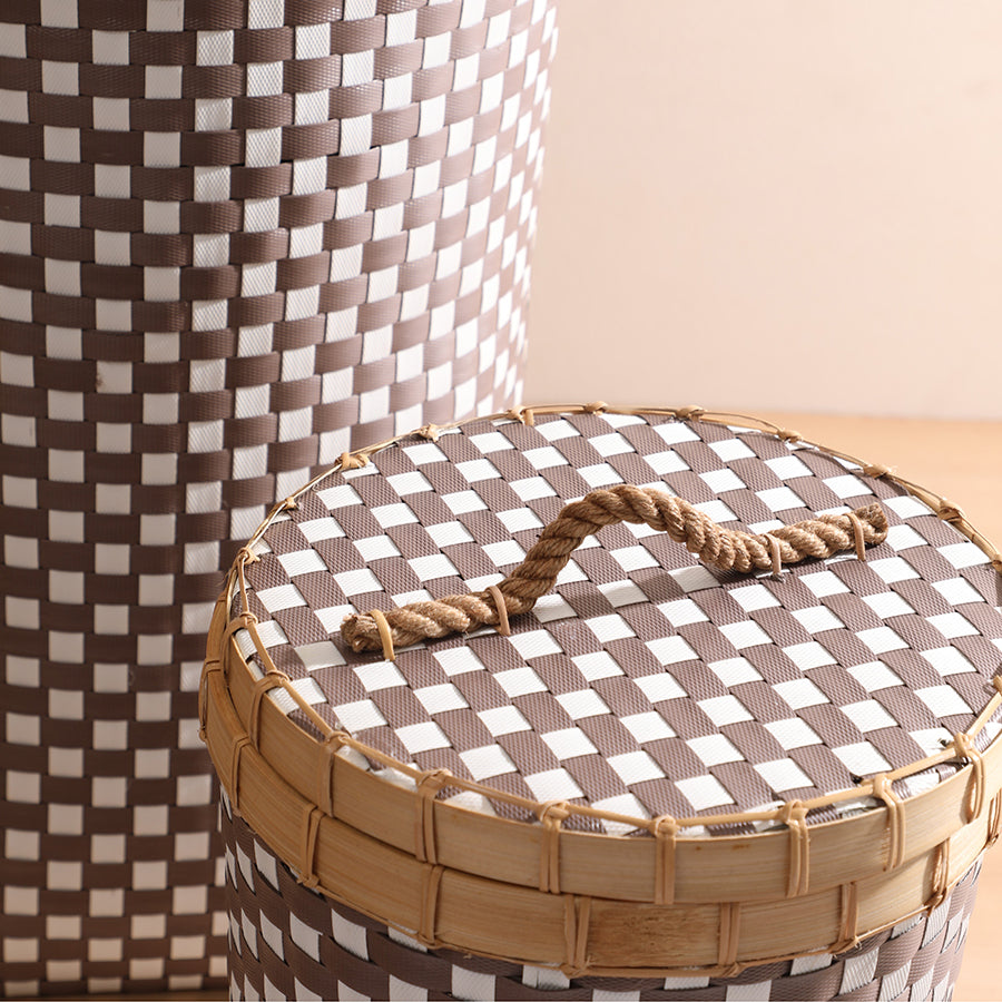 Woven storage basket, Checkered laundry basket, Decorative hamper with lid, Rope handle basket, Tall woven basket with lid, Handwoven laundry hamper, Eco-friendly storage solution, Modern woven hamper for home, Brown and white storage basket, Plastic rattan look storage bin.