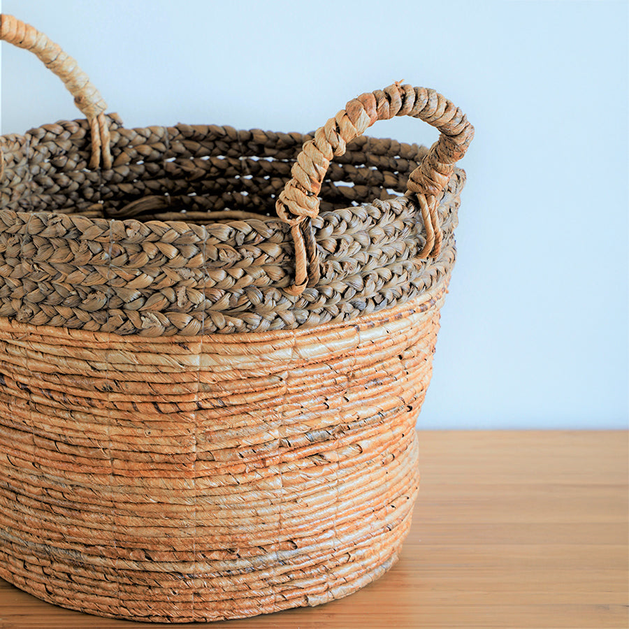 Natural woven basket with handles, Handwoven banana leaf storage basket, Rustic round seagrass basket, Eco-friendly wicker laundry basket, Decorative Boho woven basket, Large rope handle basket, Handmade natural fiber basket, Coastal style woven storage bin, Organic home décor basket,
Braided jute and banana leaf basket,
Sustainable woven floor basket, Bohemian storage basket with handles, Earthy tone woven hamper, Natural straw basket for home organization, Artisan-crafted woven basket .