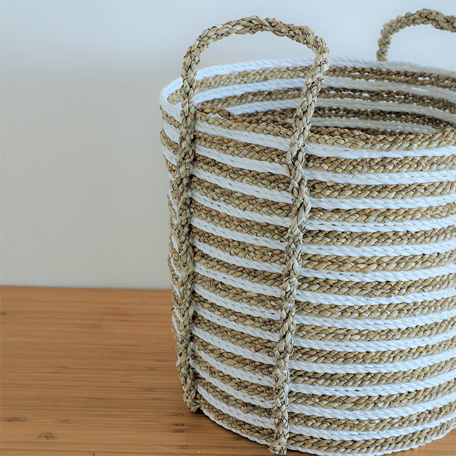 Handwoven storage basket, Natural home organization, Eco-friendly storage solutions, Decorative woven basket, Braided jute and cotton basket, White and natural woven basket, Rope basket with handles, Boho chic storage basket, Handcrafted decorative basket,
Rustic braided basket with stripes.