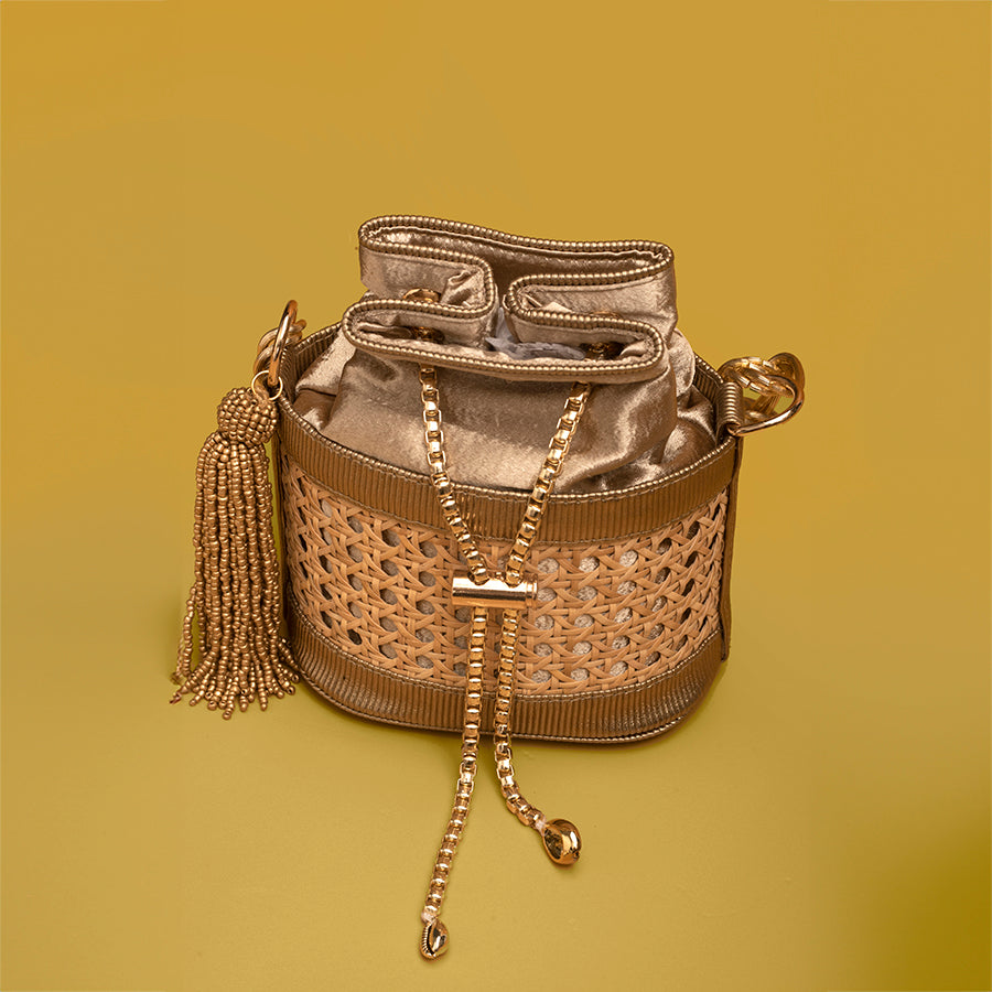 Golden cane handbag, Velvet drawstring purse, Woven rattan evening bag, Handmade bucket bag, Luxury handcrafted purse, Stylish woven clutch, Designer cane and velvet bag, Beaded tassel handbag, Women’s golden sling purse, Trendy artisan handbags, Handcrafted golden rattan bag with chain strap,
Luxurious velvet and cane drawstring handbag, Elegant woven purse for parties and weddings.