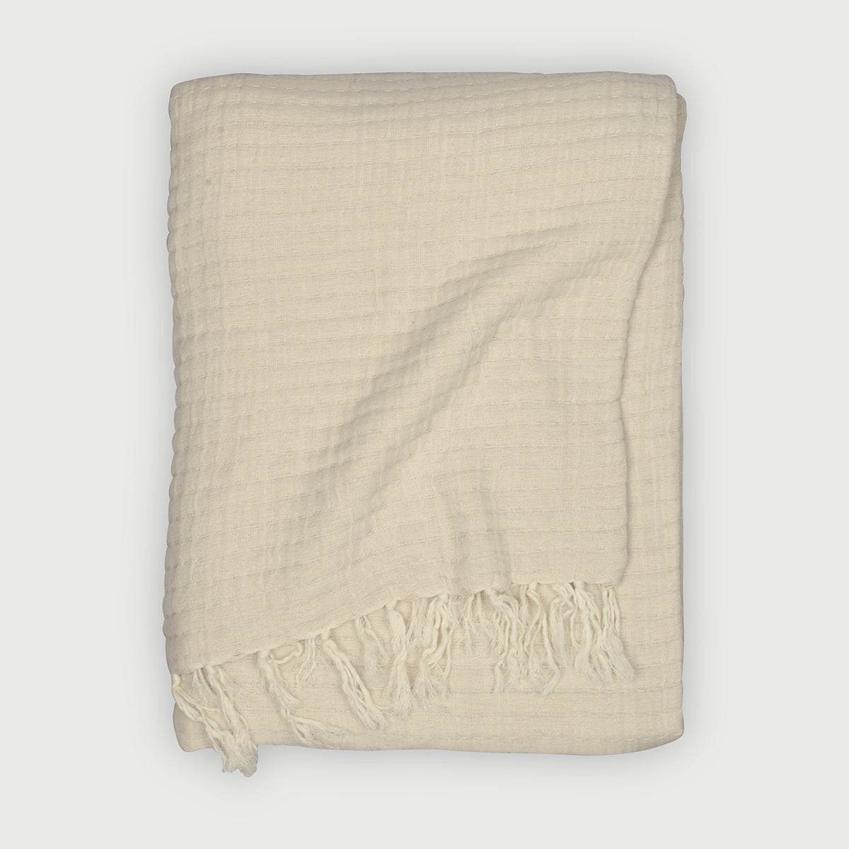 Cream throw blanket, Cotton throw blanket, Textured throw blanket, Cozy home décor, Lightweight throw blanket, Waffle weave blanket, Soft cream throw blanket for couch, Cotton waffle throw with fringes, 
Decorative lightweight blanket for living room.