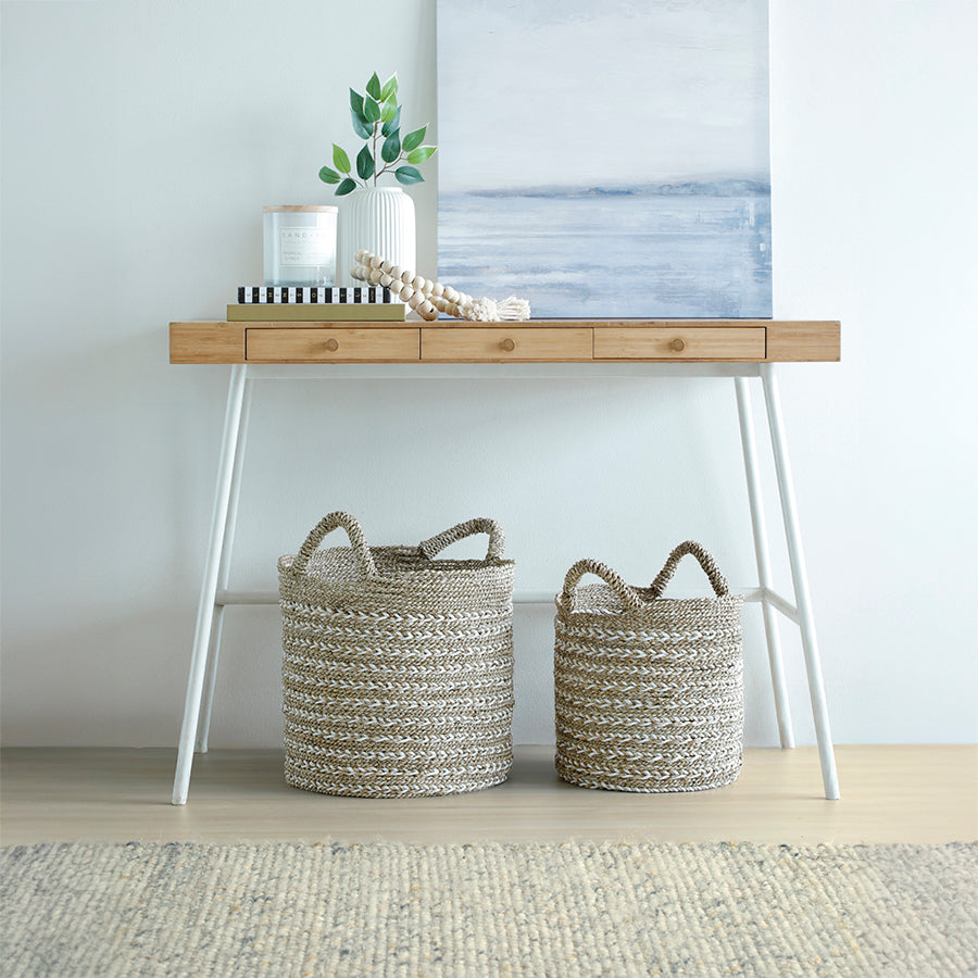 Twisted weave storage basket, Two-tone seagrass basket, Handwoven jute basket with handles, Boho woven basket, Decorative rope basket, 
Twisted weave natural storage basket with tassel, Handcrafted two-tone basket for living room, Eco-friendly woven bin for home décor, Basket with rope handles and hanging tassel charm, Seagrass and white jute decorative basket.