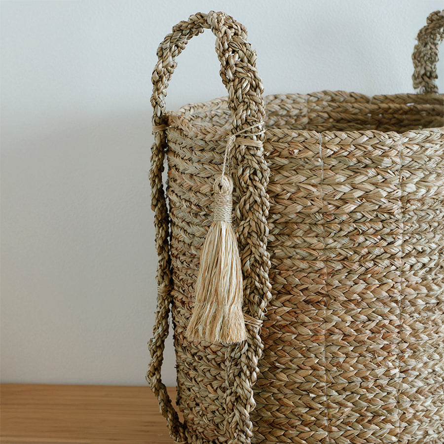 Handwoven seagrass basket, Natural fiber storage basket, Decorative woven basket, Basket with braided rope handles, Round woven basket with tassel, Handmade natural basket, Living room storage basket,
Stylish basket for blankets or pillows,
Decorative floor basket .