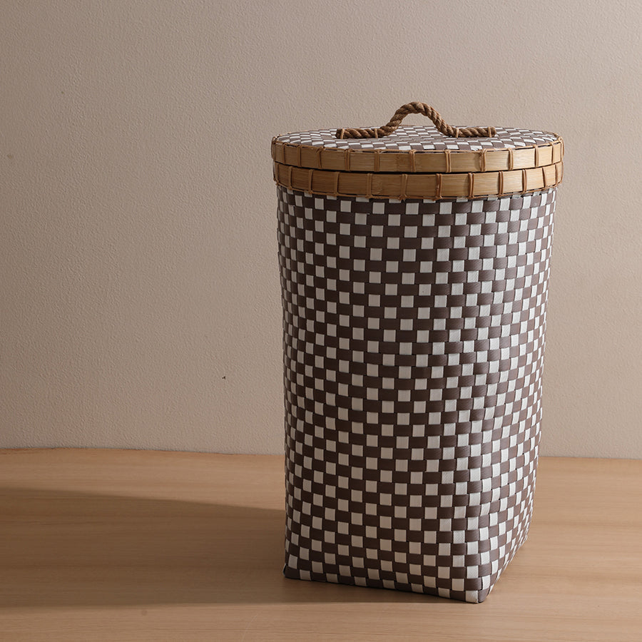 Tall woven laundry hamper, Checkered storage basket with lid, Plastic wicker laundry bin, Brown and white hamper basket, Lidded hamper for clothes storage, Vertical woven laundry basket with lid, Modern checkered hamper for bedroom,
Plastic rattan-style laundry organizer.