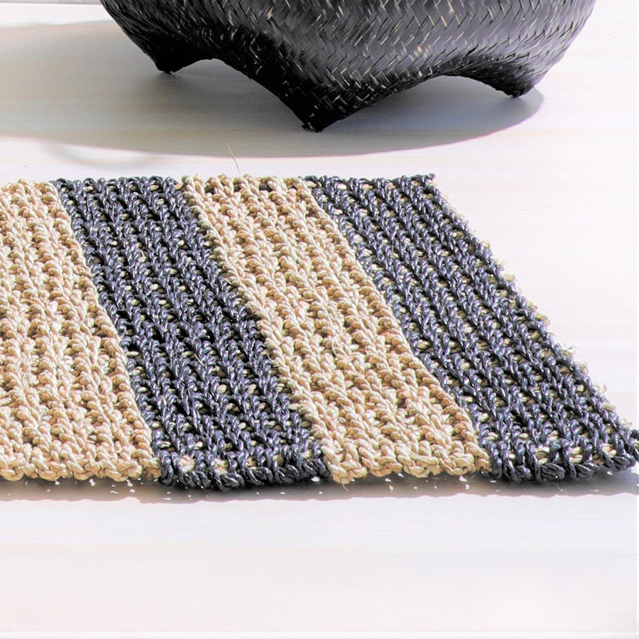 Handwoven striped jute rug, Black and natural area rug, Eco-friendly woven floor mat, Natural fiber entryway rug, Sustainable handmade jute rug, Earthy woven rug for home décor, Black stripe natural fiber rug,
Artisan made small area rug .