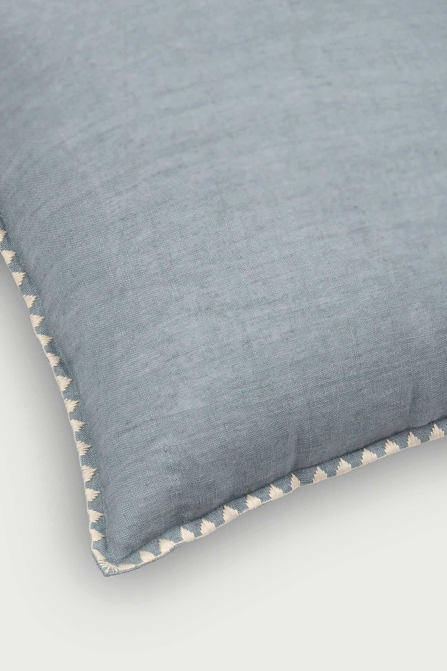 Blue linen cushion cover, Hand-stitched edge cushion, Decorative throw pillow blue, Triangle trim accent pillow, Artisan cushion for living room, Soft cotton cushion cover, Luxury decorative cushion, Boho style pillow cover, Pastel blue couch pillow, Scandinavian home décor cushion.