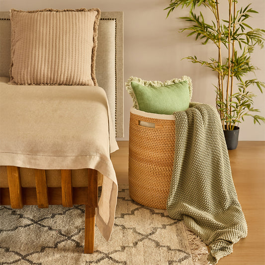 Natural woven storage basket, Cozy bedroom décor ideas, Boho style cushion and throw, Eco-friendly home accessories, Sustainable home decor accents, Minimalist bedroom aesthetic, Handwoven bamboo laundry basket, Textured pillow and blanket set, Bedroom corner styling inspiration .