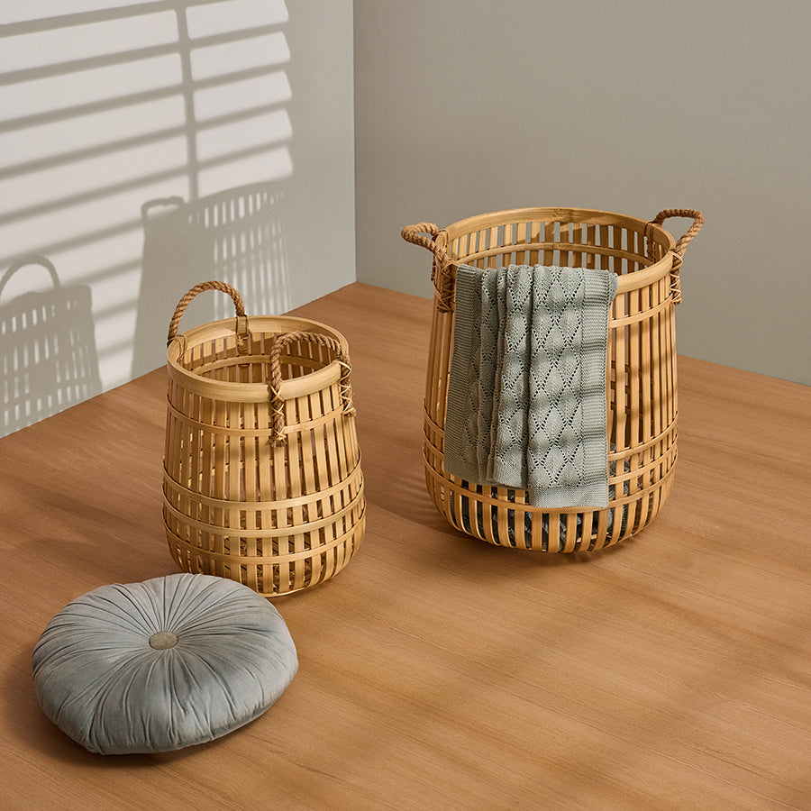 Bamboo storage basket set, Handcrafted bamboo laundry baskets, Decorative woven bamboo hampers, Soft knitted throw blanket,
Light green decorative throw,
Textured knit blanket with pattern, Round tufted floor cushion,
Velvet Boho-style round pillow.