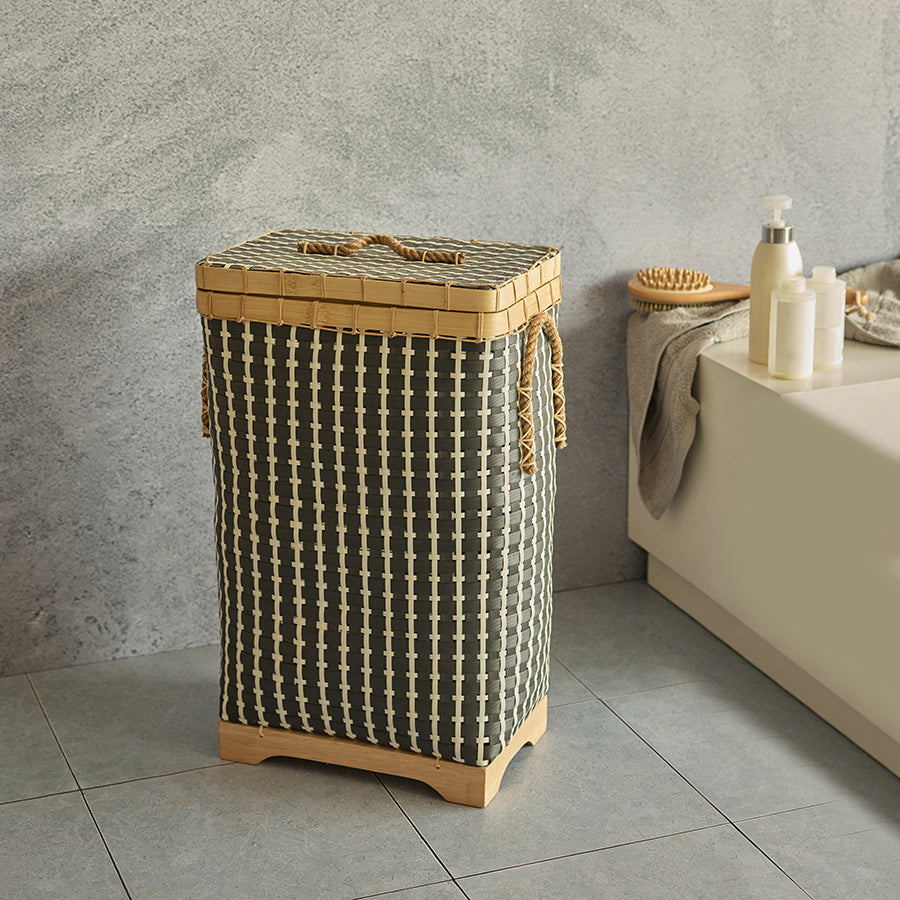Woven laundry basket with lid, Black rattan-style laundry hamper, Rectangular wicker storage bin, Modern bathroom laundry basket, Rope handle laundry hamper, Eco-friendly woven clothes hamper, Stylish woven hamper with wooden base, Space-saving bathroom laundry bin, Handmade hamper for dirty clothes, Decorative storage basket with cover.