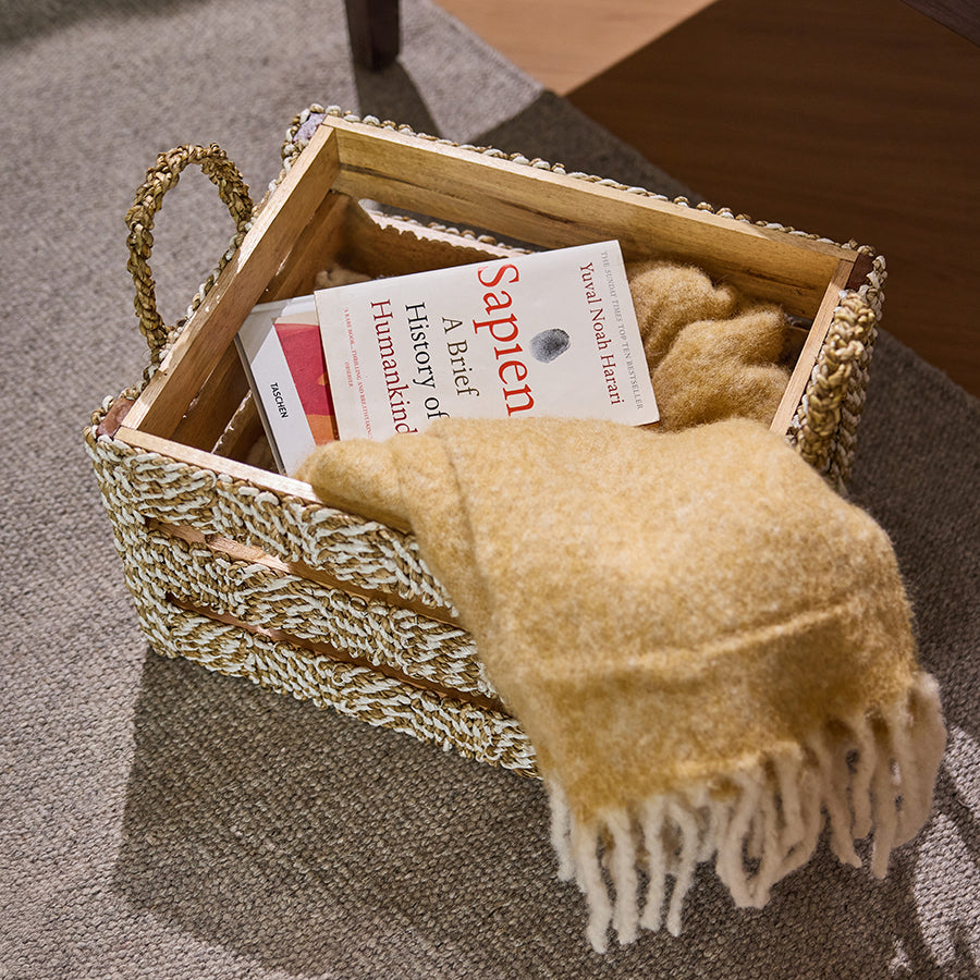 Woven rope storage basket, Natural rope and wood crate, Cozy book and blanket basket, Handcrafted woven organizer, Eco-friendly rope basket,
Rustic wood and rope storage bin, Floor basket for books and blankets,
Reading corner storage solution.