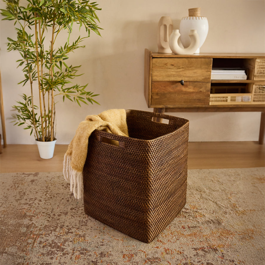 Woven storage basket, Rattan laundry basket, Handwoven basket bin, Large wicker basket, Brown woven hamper, Handcrafted rattan storage bin, Eco-friendly laundry basket for home, Decorative wicker basket with handles, Natural woven basket for blankets, Stylish basket for living room storage.