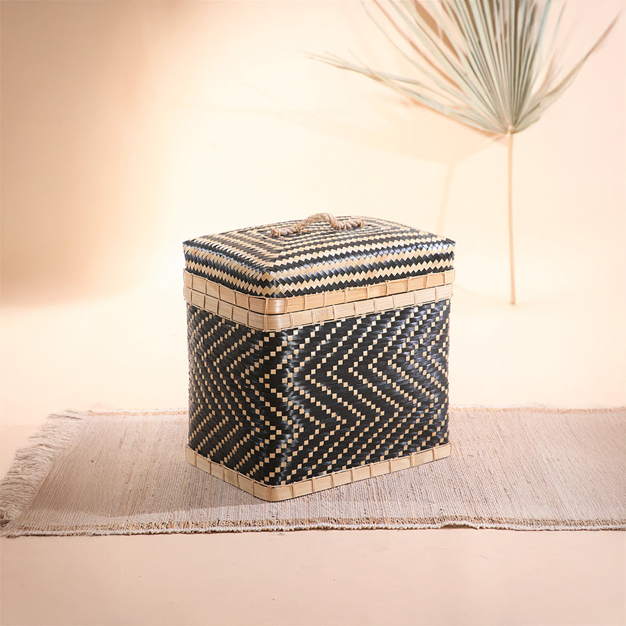 Woven bamboo storage basket,
Black and beige chevron hamper, Handwoven basket with lid, Boho natural fiber storage box, Sustainable bamboo trunk basket, Artisan handmade lidded hamper, Decorative storage basket with handle, Eco-friendly woven laundry basket, Zigzag pattern rattan bin, Multipurpose storage solution.
