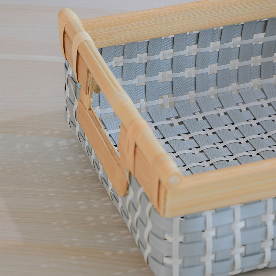 woven storage basket, plastic wicker basket, rectangular organizer basket, storage bin with handles, decorative storage basket, medium-sized storage basket, bamboo frame storage basket, grey and white woven basket, household organization basket, multipurpose storage container, plastic woven basket with bamboo handles, decorative storage bin for shelves,
grey and white basket for bathroom storage, woven storage organizer for closet, eco-friendly home storage basket.
