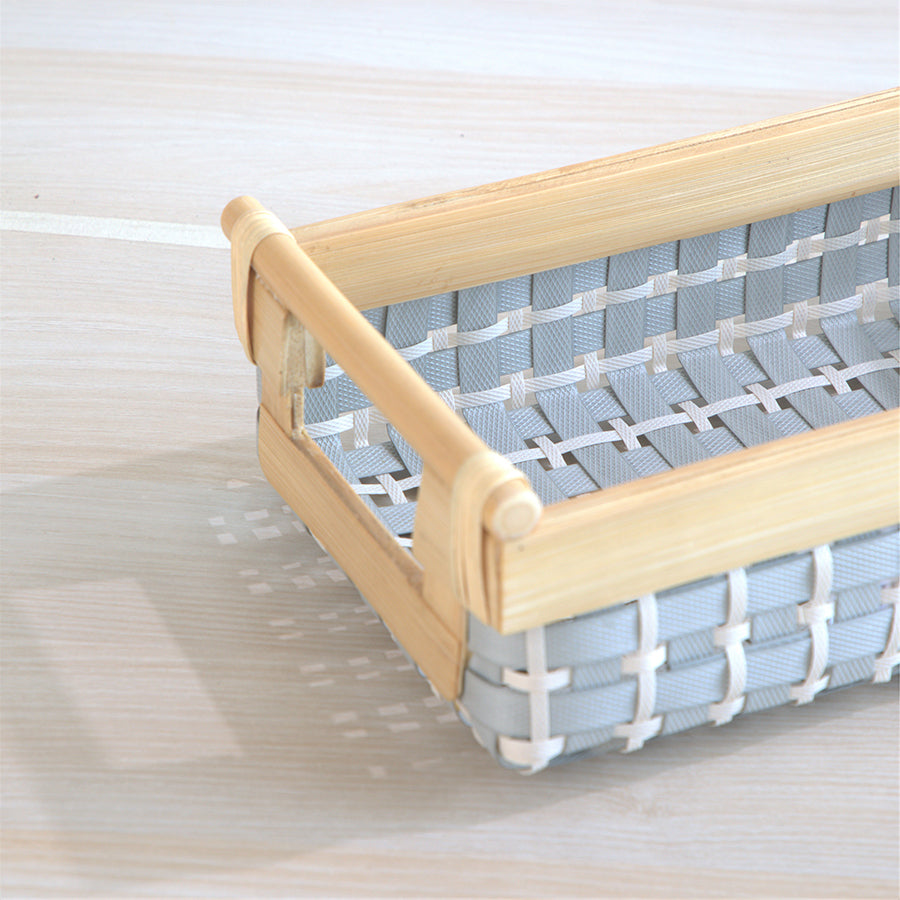 small woven storage basket, plastic wicker organizer bin, grey white storage container, bamboo frame basket, small household storage basket, decorative woven bin, mini organizer for shelves, stylish desk storage basket, compact storage solution, plastic basket with wooden handles, small plastic wicker basket with bamboo frame,
grey and white mini organizer for drawers .
