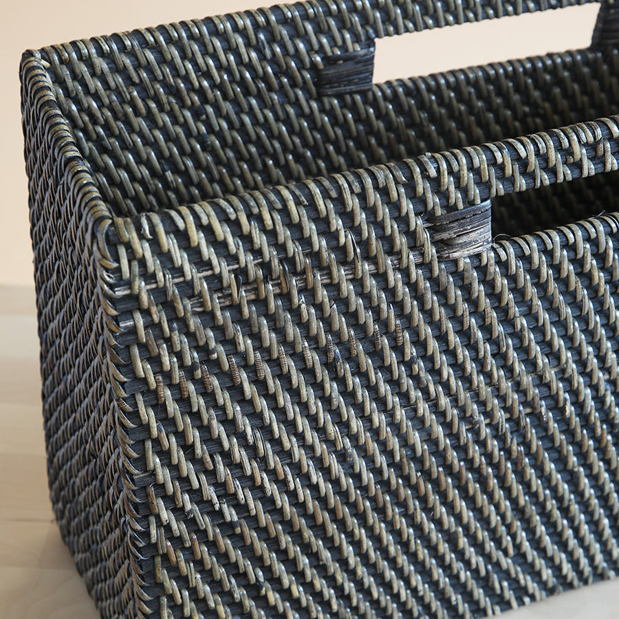 Handwoven rattan magazine holder, Black and natural wicker basket, Artisan-made newspaper organizer, 
Durable synthetic wicker magazine bin, Eco-friendly woven storage basket, Intricately woven magazine rack, Dual-tone rattan texture basket, 
Structured rectangular storage bin, Premium quality wicker organizer, 
Textured handwoven basket with handles.