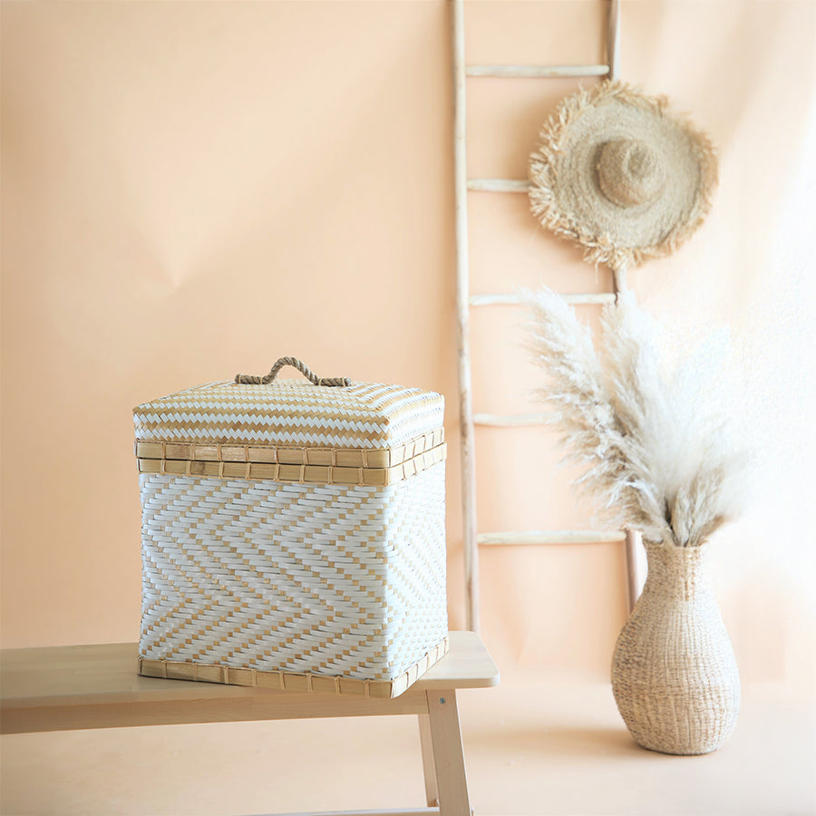 White woven storage basket, Handwoven bamboo hamper, White and beige chevron basket, Eco-friendly storage box with lid, Boho style trunk basket, Artisan natural fiber hamper, Sustainable bamboo basket, Decorative lidded storage bin, Multipurpose woven organizer, Coastal style laundry basket.