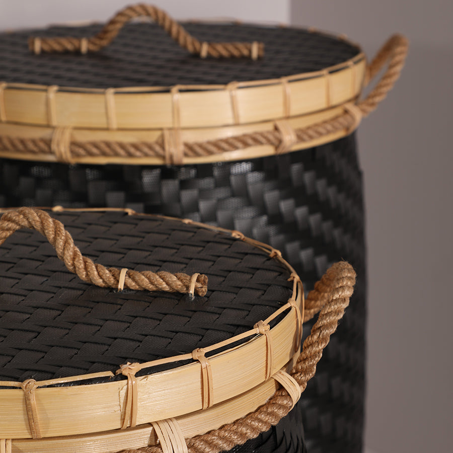 Black woven storage basket with lid, Handwoven basket with rope handles, Bamboo lidded storage hamper, Eco-friendly black storage bin, Black laundry basket set, Decorative woven home baskets, 
Plastic weave and bamboo basket, Rope handle hamper, Durable handcrafted basket set, Textured black woven container, Artisan bamboo-lid storage baskets. 