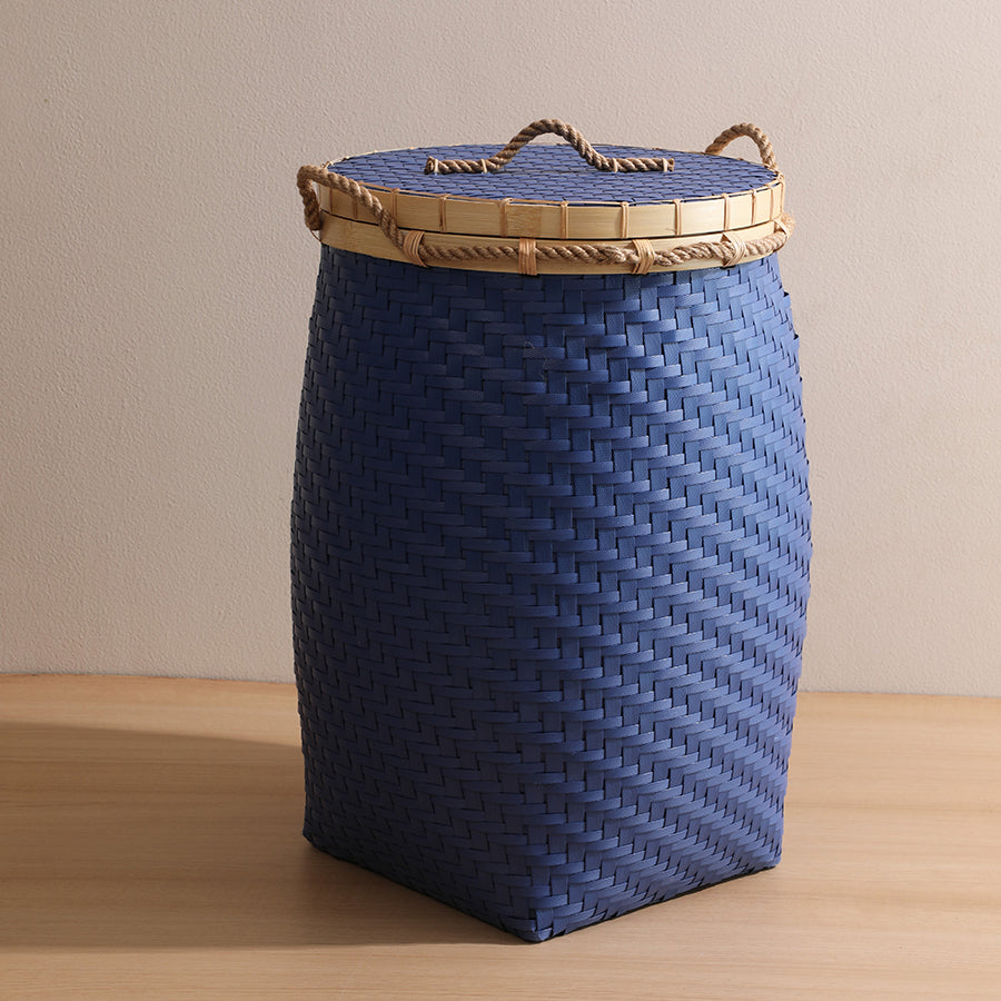 Blue woven storage basket, Lidded laundry hamper, Rattan laundry basket, Wicker storage bin with lid, Handwoven clothes hamper, Rope handle woven basket, Blue wicker laundry bin, Decorative woven hamper, Lidded storage solution, Eco-friendly storage basket. 