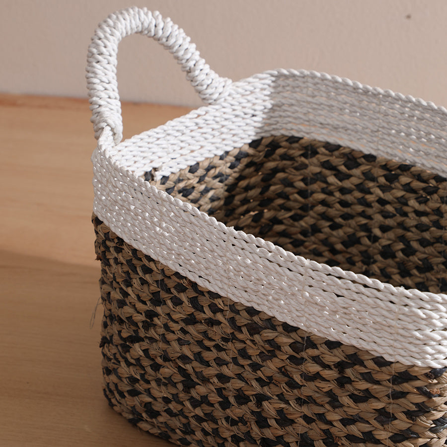 Two-tone woven basket, Handwoven storage basket, Natural fiber decorative basket, Seagrass and rope basket, White and brown storage bin, 
Eco-friendly woven basket, Rectangular storage basket with handles, Seagrass basket with white accent, Coastal style home décor basket, Braided rope utility basket .

