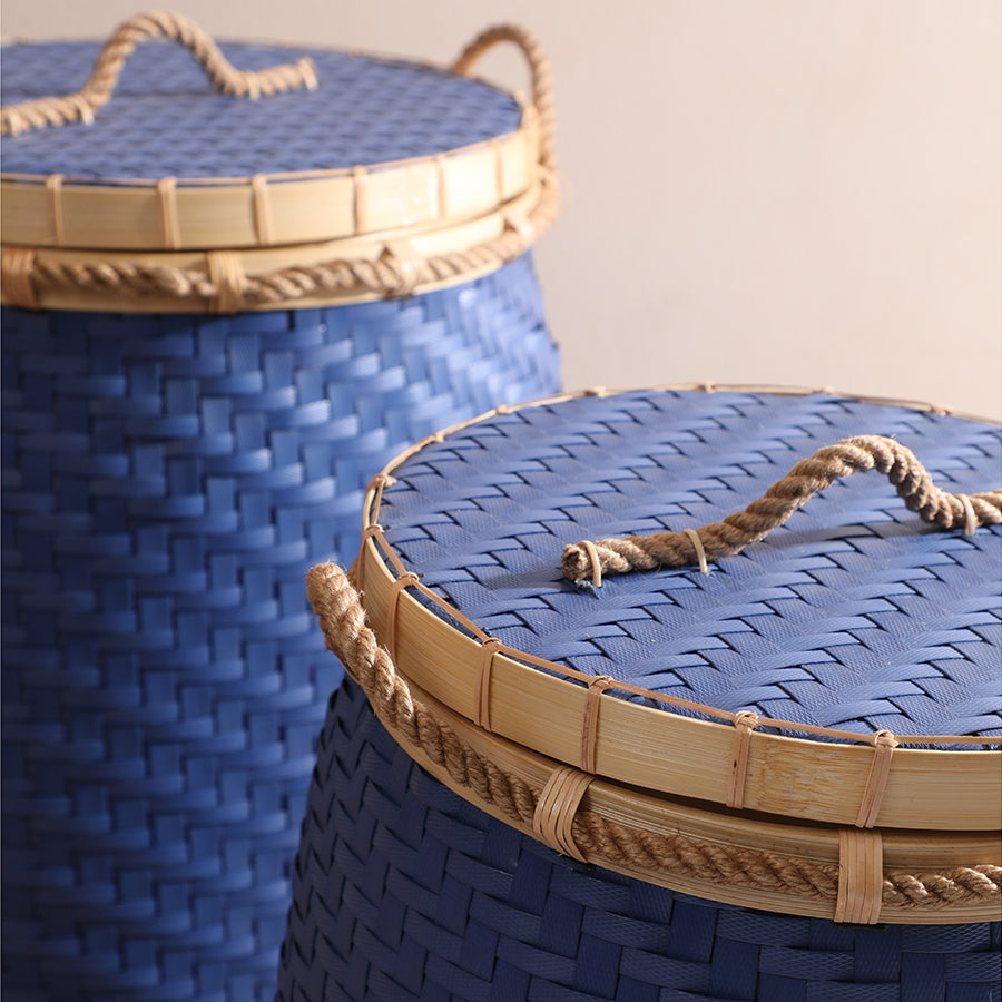 Blue woven basket with lid, Rope handle storage basket, Lidded wicker laundry hamper, Handcrafted rattan basket, Woven bamboo hamper, Decorative woven basket, Eco-friendly wicker bin, Blue laundry storage basket, Rope-handled hamper, Artisan handwoven basket. 

