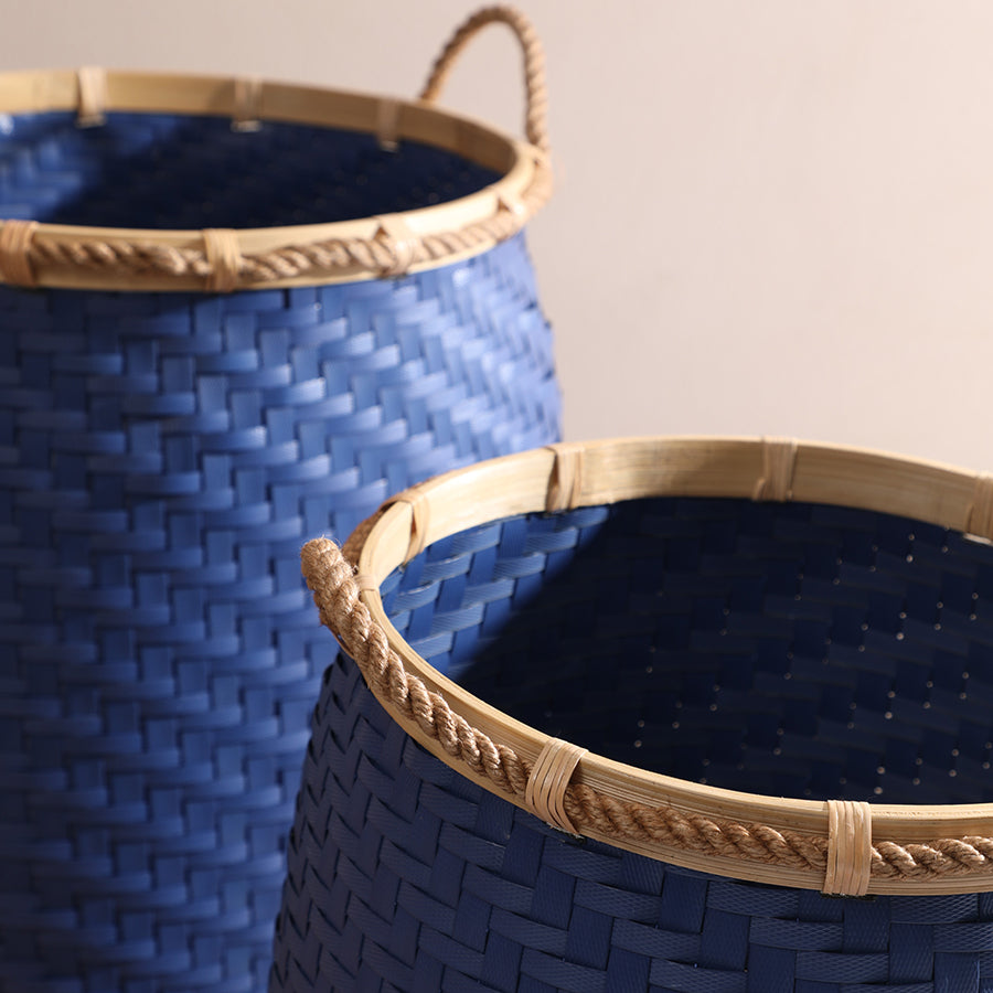 Blue woven storage basket, Rope handle wicker basket, Handwoven rattan bin, Bamboo rim laundry basket, Open-top wicker hamper, Decorative woven bin, Eco-friendly storage basket, Boho woven organizer, Handmade rattan basket, 
Blue wicker laundry bin. 