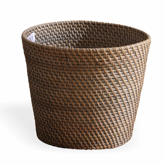 Woven rattan storage basket, Brown laundry hamper, Handcrafted wicker basket, Open-top woven bin, Eco-friendly rattan basket, Natural brown handwoven laundry basket, Tapered rattan storage bin for clothes, Rustic style wicker basket for home organization, Durable handmade basket for multipurpose use. 