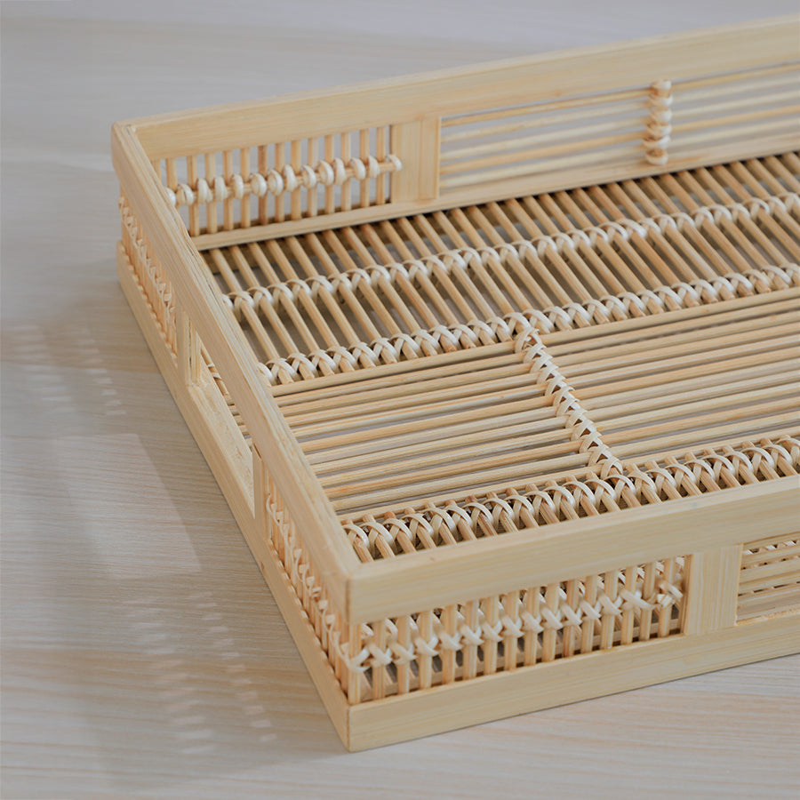 rattan serving tray, bamboo tray, woven tray, natural fiber tray, handmade serving tray, rustic kitchen tray, eco-friendly bamboo tray, rectangular woven tray, cane weave tray, woven bamboo detail, handcrafted tray, artisan bamboo tray,  wicker pattern tray. 