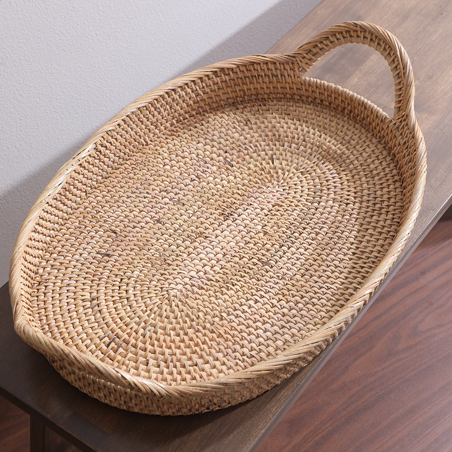 Oval rattan serving tray, Handwoven wicker tray, Natural rattan basket tray, Rustic kitchen tray, Boho home décor tray, Handmade wicker basket tray, Sustainable rattan homeware.



