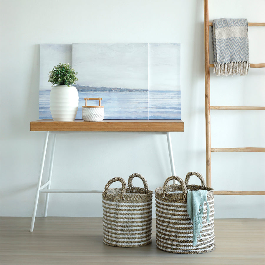 Striped rope storage baskets, 
Handwoven jute and cotton baskets, 
Eco-friendly natural fiber baskets, Decorative storage baskets with handles, Cylindrical seagrass laundry baskets, Rustic white and beige woven bins, Multipurpose home storage baskets, Farmhouse-style rope baskets, Coastal rope organizer baskets, Artisan woven baskets for home. 

