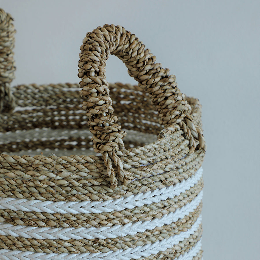 Handwoven rope basket, Natural fiber storage basket, Seagrass and cotton basket, White striped woven basket, Braided handle storage bin,
Cylindrical jute rope basket, Coastal style woven basket, Rustic rope basket with handles, Handmade basket with thick braiding, Eco-friendly woven home storage. 

