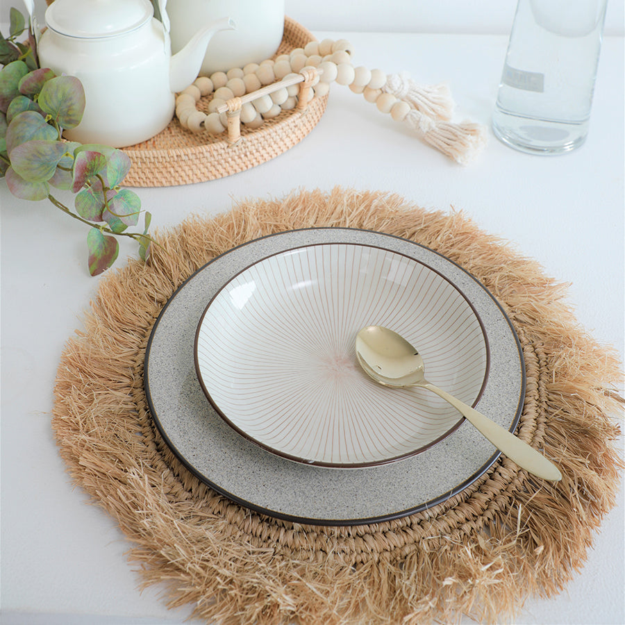 natural fringe placemat, woven straw placemat, Boho round placemat, 
seagrass table mat, rustic fringe charger, braided placemat, 
eco-friendly natural placemat, coastal style table mat, ceramic dinnerware set, artisan ceramic plate, 
stoneware dinner plate, handmade ceramic bowl, neutral tone dishware. 