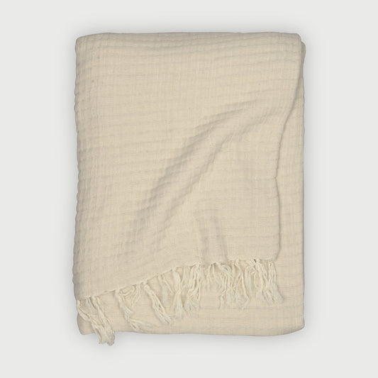 Cream throw blanket, Cotton throw blanket, Textured throw blanket, Cozy home décor, Lightweight throw blanket, Waffle weave blanket, Soft cream throw blanket for couch, Cotton waffle throw with fringes, 
Decorative lightweight blanket for living room.