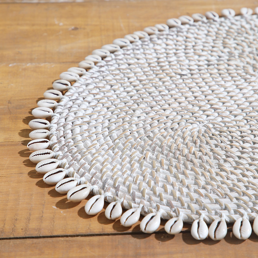cowrie shell placemat, coastal woven placemat, natural shell table mat, 
handmade shell placemat, bohemian table décor, tropical dining placemat, 
beach style table setting, woven oval placemat, decorative shell edge placemat, eco friendly table placemat, rustic coastal placemat, 
artisan shell woven mat, white shell Boho placemat, seaside table accessories, handcrafted shell edge mat. 