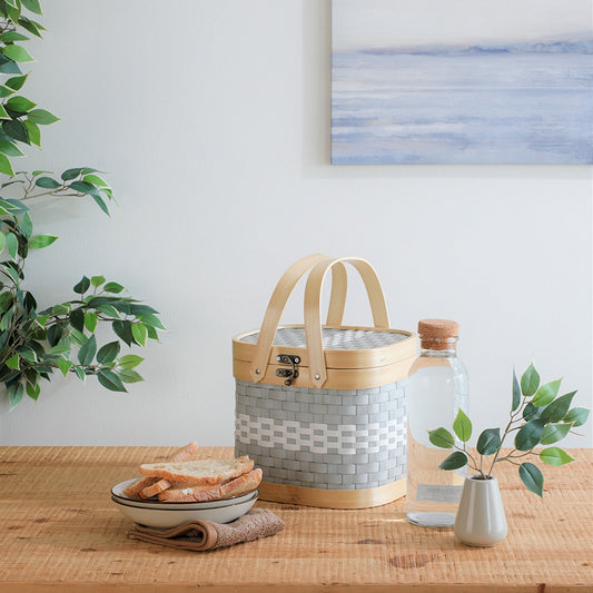 Small tiffin basket, Woven grey and white basket, Bamboo handle food basket, Handcrafted lunch basket, 
Compact picnic basket with lid, 
Modern kitchen storage basket, 
Decorative tiffin box basket, Eco-friendly lunch organizer, Rustic picnic table setup, Home décor storage basket, Minimalist lifestyle product, 
Nordic home accessories, Natural wood and woven basket, Scandi-style dining décor, Soft tone kitchen essentials. 


