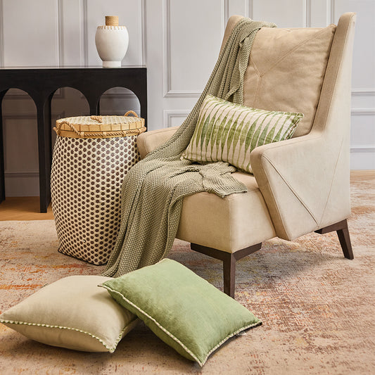 Woven storage basket with lid, Tall decorative laundry hamper, Handcrafted basket with bamboo and rope, Stylish lidded basket for living room, Brown and cream woven hamper, Modern beige upholstered armchair, High-back accent chair for living room, Comfortable fabric armchair with wooden legs, Contemporary lounge chair for home décor, Soft padded reading chair. 

