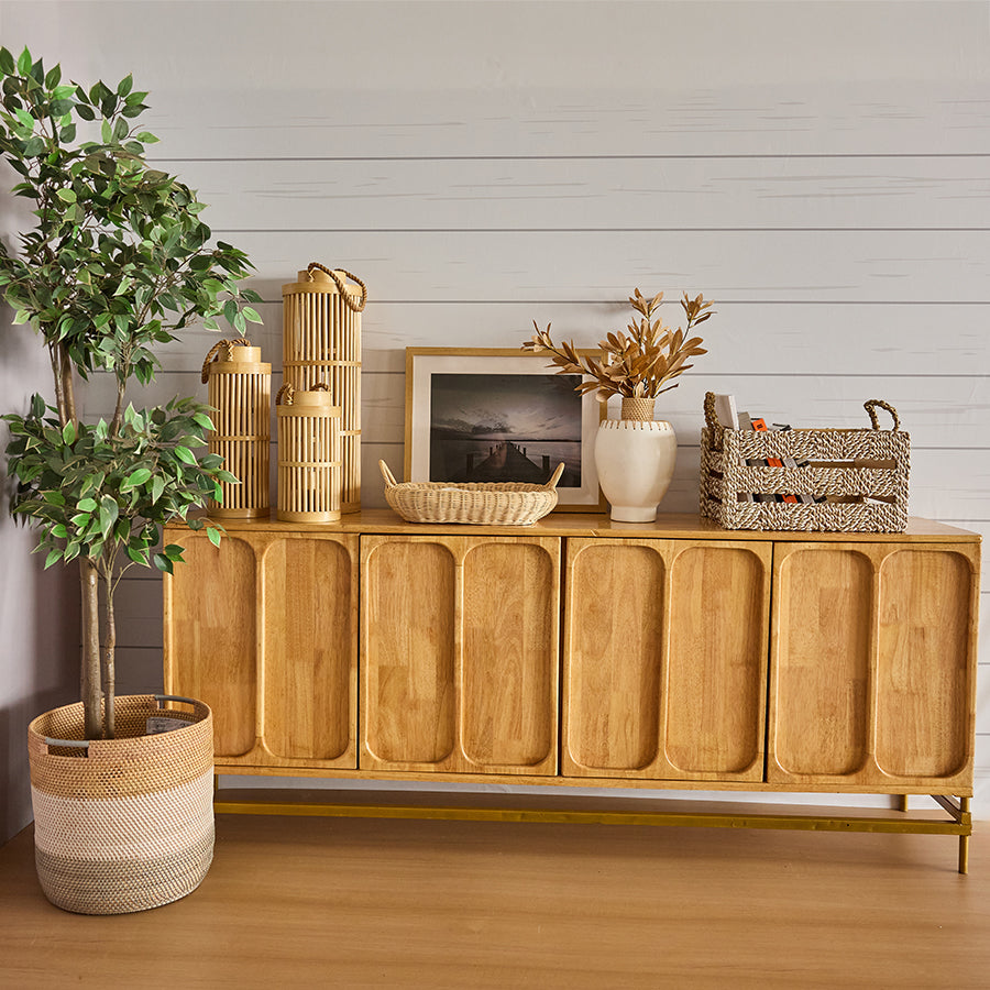 Rectangular wicker tray, Handwoven rattan basket, Bamboo lantern décor, 
Tall woven candle lanterns, Faux indoor tree, Artificial ficus plant, White ceramic vase, Minimalist vase décor, Braided storage basket, 
Woven organizer bin with handles, 
Decorative storage box, Mid-century modern console, Solid wood sideboard.





