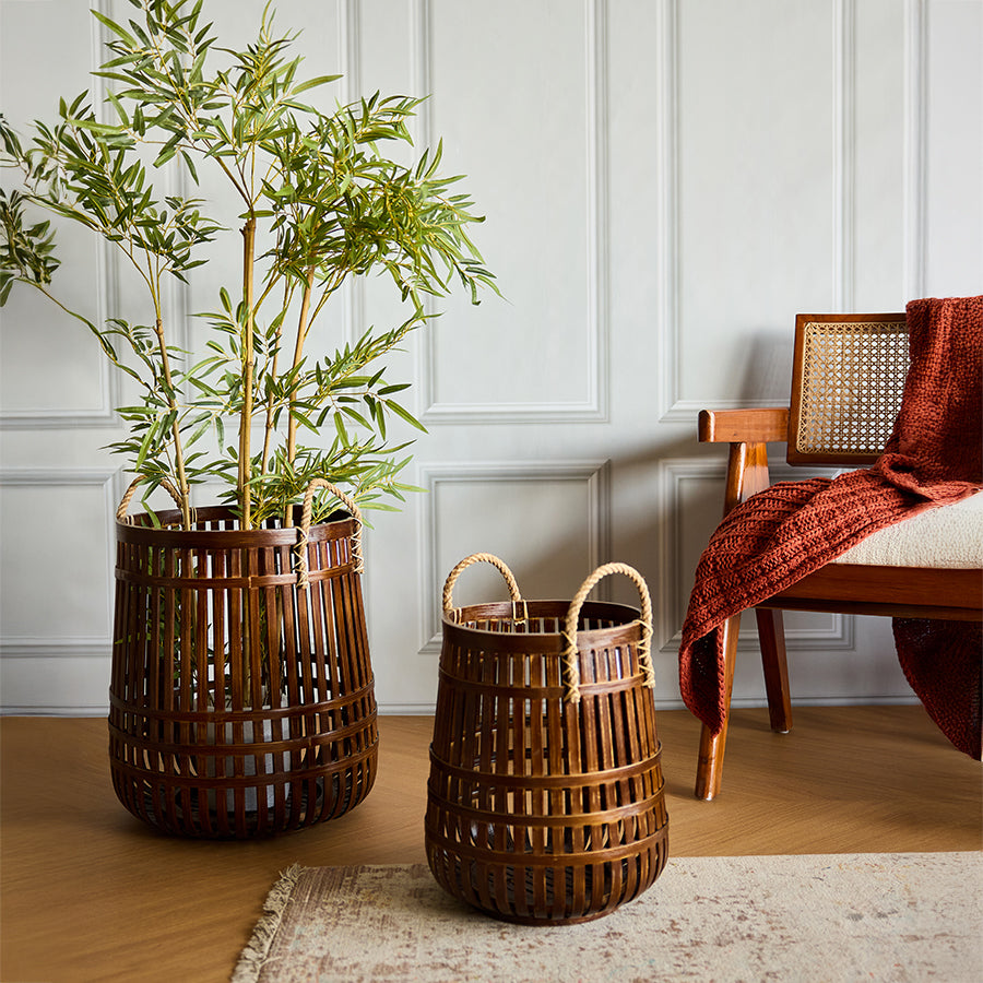 Boho home décor, Modern rustic décor, Minimalist home accessories, Woven bamboo basket, Handmade bamboo storage basket, Mid-century modern wooden chair, Cane back wooden chair, Chunky knit throw blanket, Rust-colored throw, 
Decorative basket with handles.