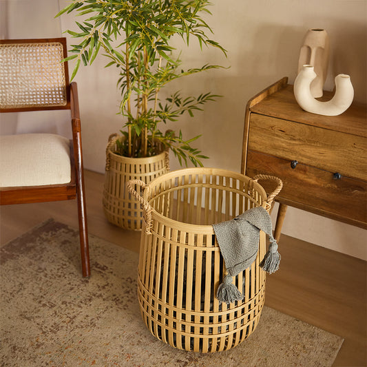 Decorative bamboo basket, Open weave bamboo basket, Faux bamboo plant décor, Indoor potted plant, Solid wood side cabinet, Rustic wooden console, Ceramic modern vase, Natural home décor ideas.




