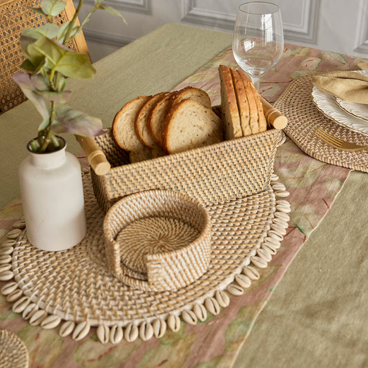 coastal shell placemat, cowrie shell woven placemat, rattan bread basket, woven bread tray, Boho style table décor, rustic woven napkin holder, 
farmhouse bread basket, 
natural woven table accessories, 
coastal dining table styling, 
beach house table décor, handmade table placemat, tropical table setting ideas, eco friendly woven basket, 
artisanal table accessories, decorative bread basket. 