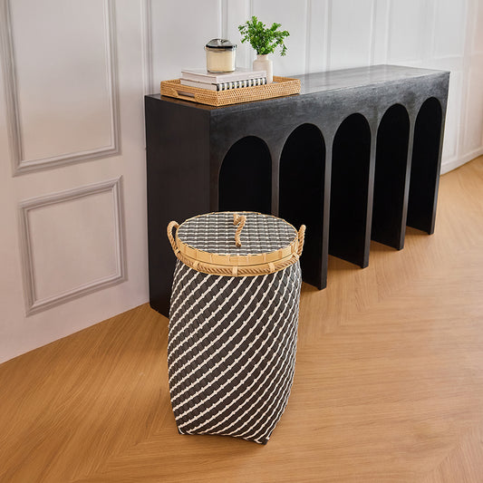 Lidded woven storage basket, 
Black and white hamper basket, 
Decorative basket with lid and handles, Handwoven laundry hamper, Black and white handwoven basket for laundry or storage, Stylish woven hamper with rope handles and lid, 
Decorative Boho basket for home entryway or bedroom.