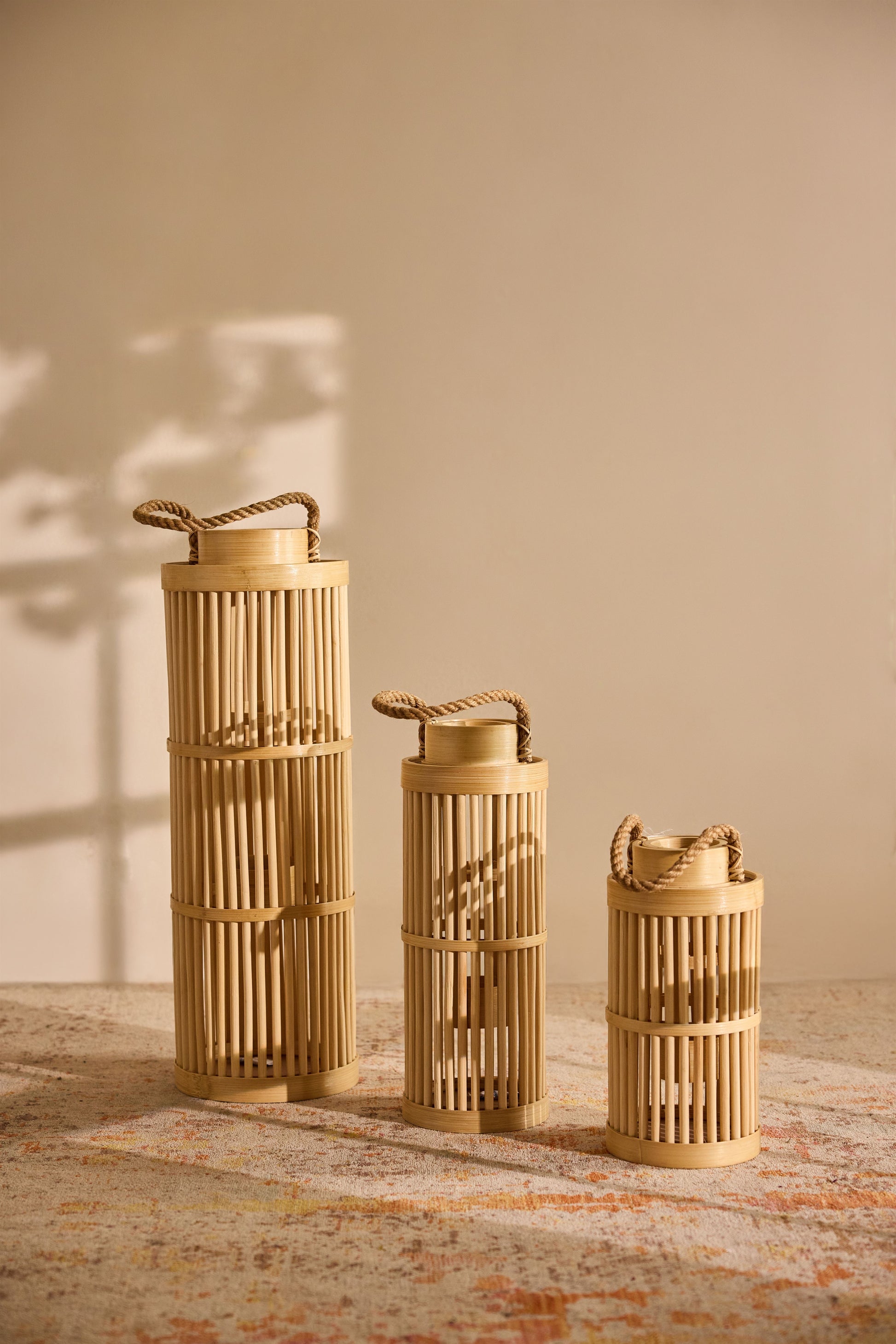 Rope handle lanterns, Natural bamboo candle holders, Decorative bamboo lanterns, Japandi style décor, Minimalist home accessories, 
Boho lantern décor, Rustic indoor lighting, Artisan home accessories, 
Slatted bamboo design, Entryway styling pieces, Cozy home light accents, Decorative floor lanterns. 