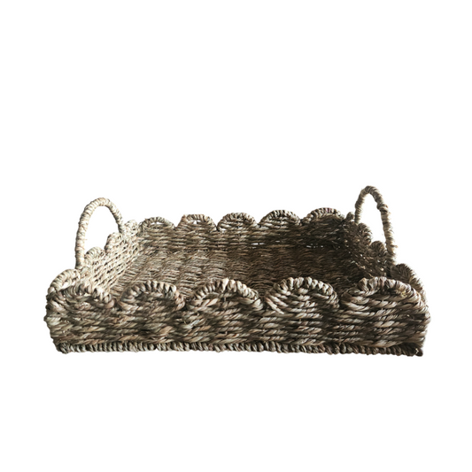 Woven serving tray with handles, Scalloped edge rattan tray, Natural fiber decorative tray, Handwoven seagrass tray, Rectangular wicker tray, Rustic woven breakfast tray, 
Boho decorative serving tray, Water hyacinth tray for home décor, Handmade tray with scalloped design, Eco-friendly table centerpiece tray. 

