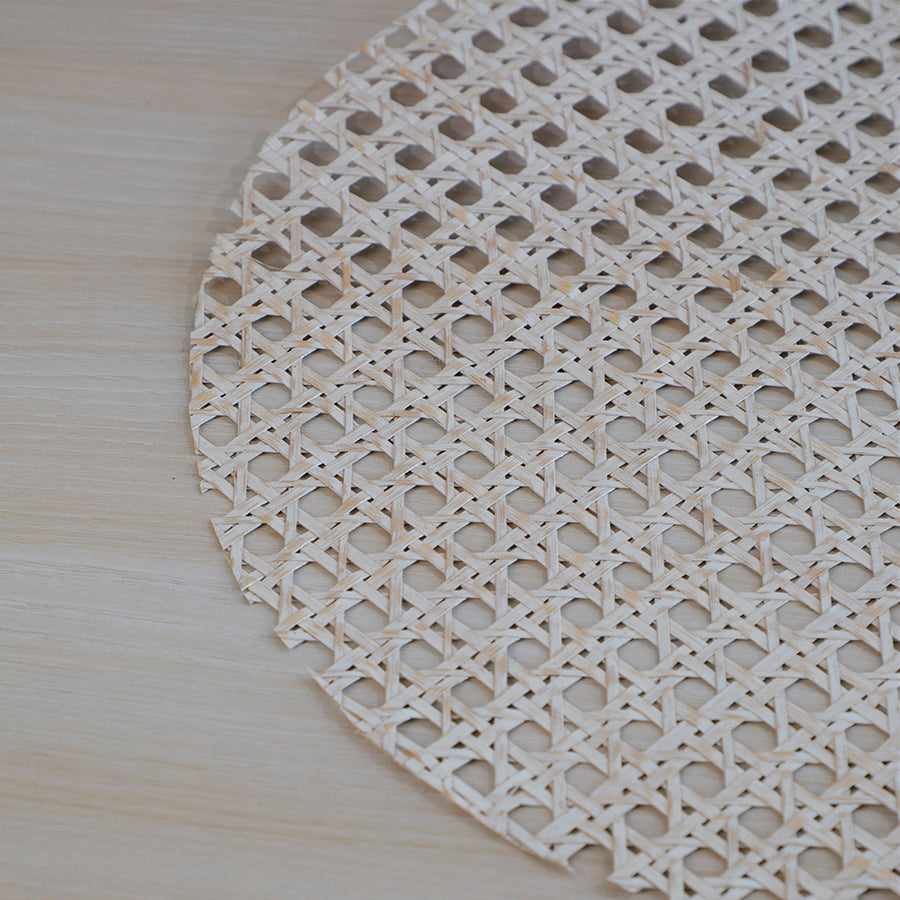 woven placemat, rattan placemat, cane placemat, round woven table mat, natural fiber placemat, handmade table mat, Boho chic placemat, rustic woven placemat, farmhouse table mat, white cane placemat, whitewashed rattan placemat, ivory woven placemat, neutral tone placemat, off-white woven mat. 