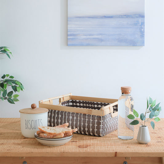Woven storage basket, Brown and white organizer basket, Plastic rattan bin with wood handles, Decorative woven tray, Eco-friendly home storage basket, Rectangular woven storage box, Minimalist storage container, Rustic kitchen basket, 
Tabletop organizer with wooden frame .

