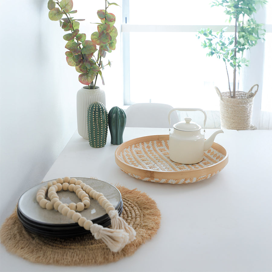 Boho home décor, Minimalist interior accessories, Scandinavian home styling, Natural décor elements, Eco-friendly home décor, Handwoven rattan tray, Bamboo serving tray, Boho decorative tray, Aztec pattern tray, Natural fiber tray, Vintage ceramic teapot, White teapot with handle, Minimalist tea kettle
White ribbed ceramic vase, Decorative faux plants, Ceramic cactus décor, 

